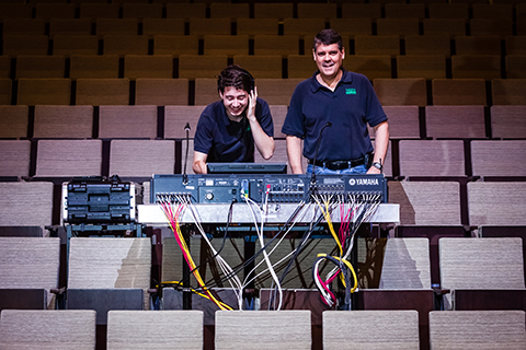Student working on a soundboard for a concert